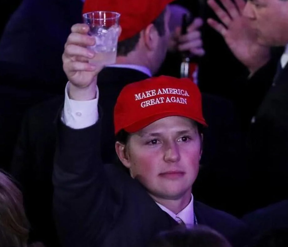 Devin Dreeshen in a Make America Great Again hat, raising a drink at Trump's 2016 election night party.