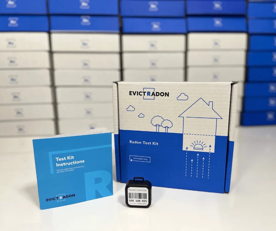 An Evict Radon test kit: a blue and white box, an instruction booklet and a small black radon detector.